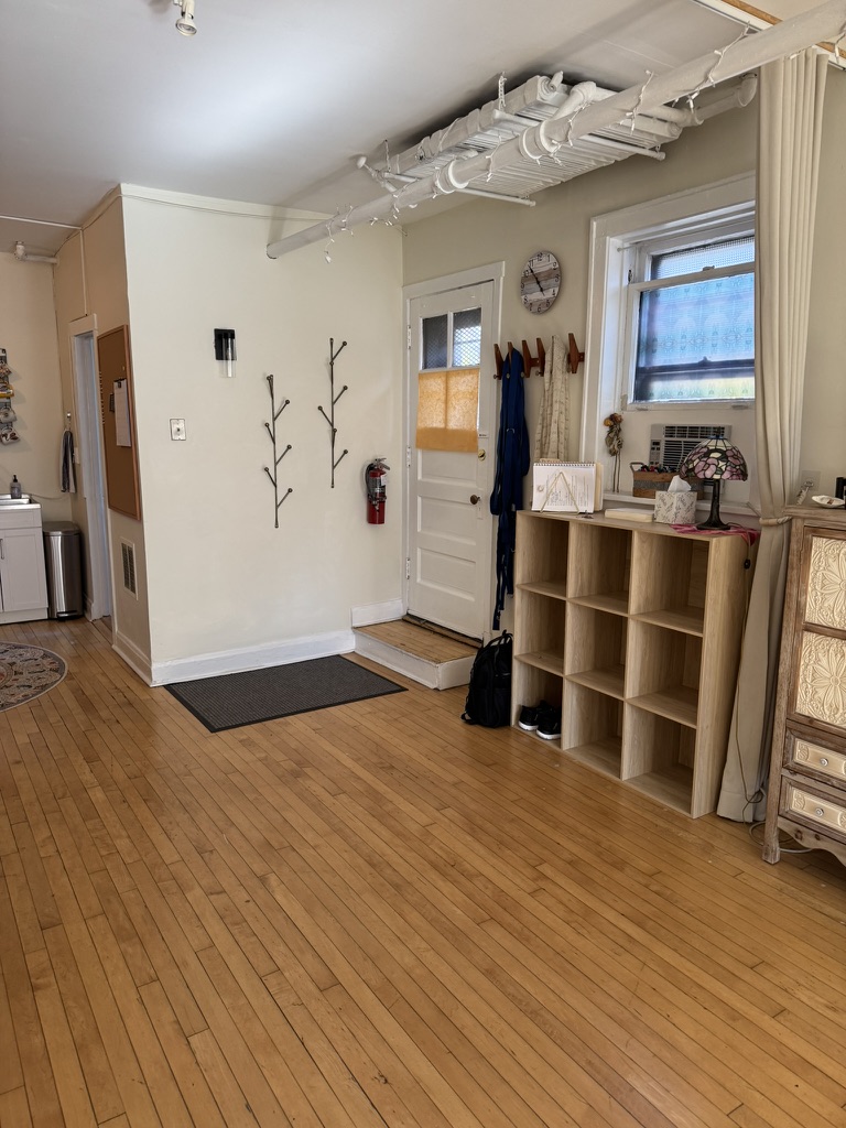 Studio entry with coat hooks, cubbies, and natural light